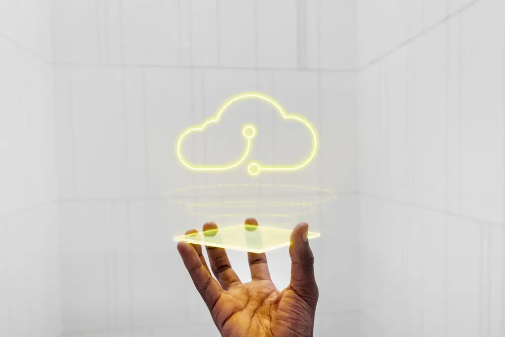 a person holding a neon cloud sign